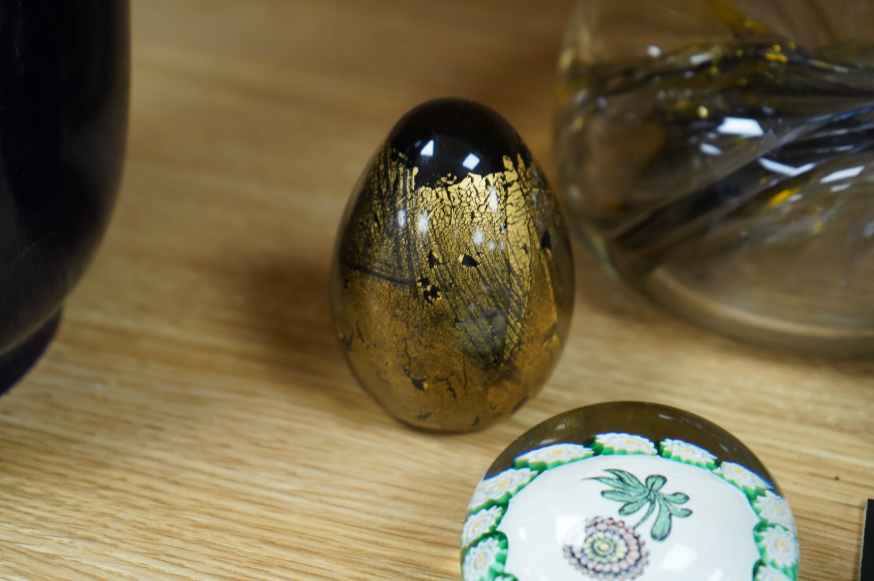 Brian Lonsway (American), an art glass ornamental dish, two Isle of Wight glass eggs and a floral paperweight, tallest 8.5cm